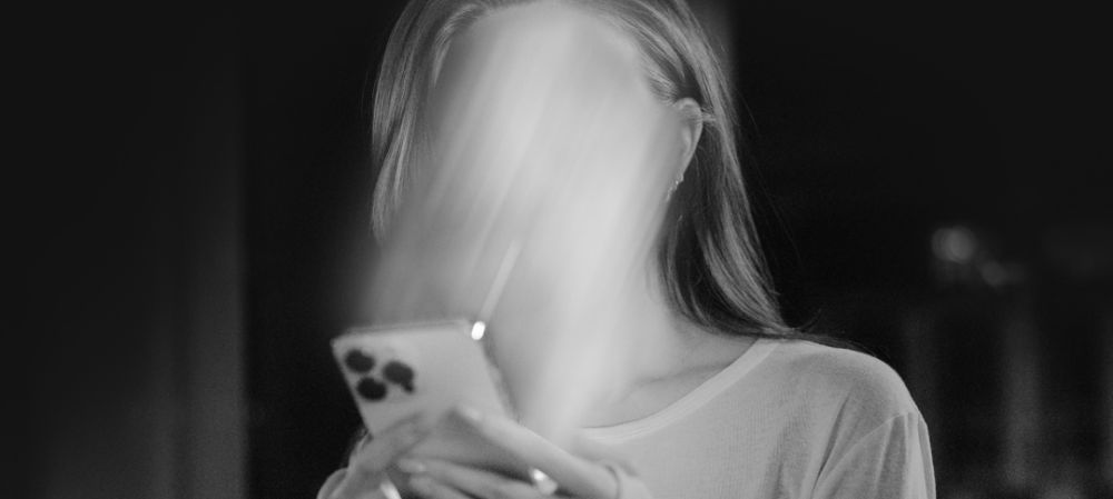 Woman with face sucked into phone